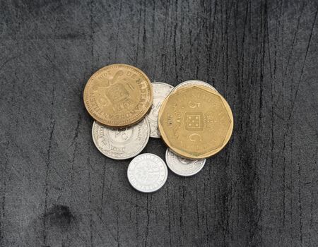Close up of Stable of Netherlands Antillean guilder coins on black backgroundの写真素材