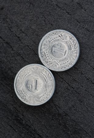 close up of 10 (ten) cent Netherlands Antillean guilder coin on black background