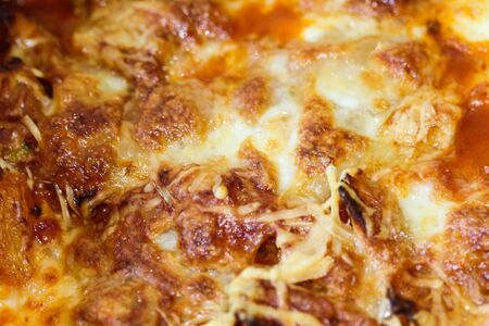 close up macro of melted old dutch cheese and mozzarellaの写真素材