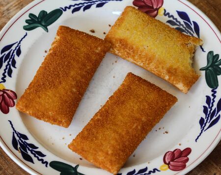 close up of kaassoufflÃ©, a Dutch snack of melted cheese inside a thin dough-based wrap