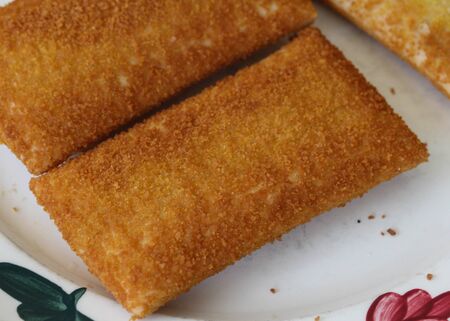 close up of kaassoufflÃ©, a Dutch snack of melted cheese inside a thin dough-based wrap