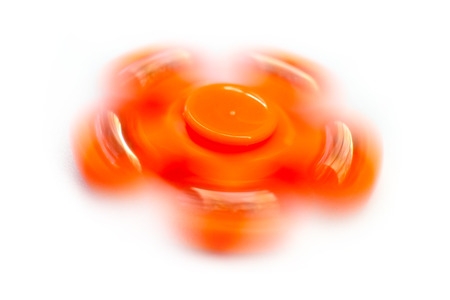 Low speed shutter of orange spinning fidget spinnerの写真素材