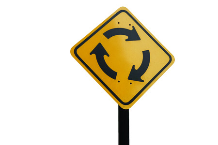 Roundabout traffic yellow sign in clockwise with black pole on white background. It can be flipped to counter clockwise direction.の写真素材