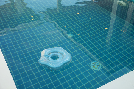 Baby life ring floating in full water swimming poolの写真素材
