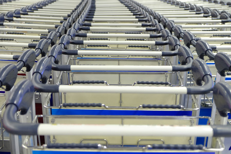 Handles of empty carts in straight rows
