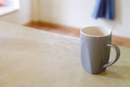 Empty glass of coffee with grunge, on the wood table in living roomの写真素材
