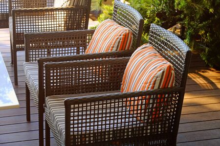 Beautiful armchairs with pillows on wood outdoor balcony