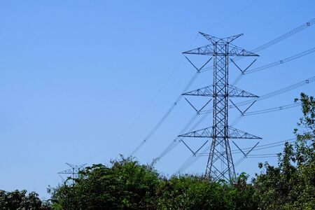 Super big high voltage electrical structured pole and transmission line on blue sky background