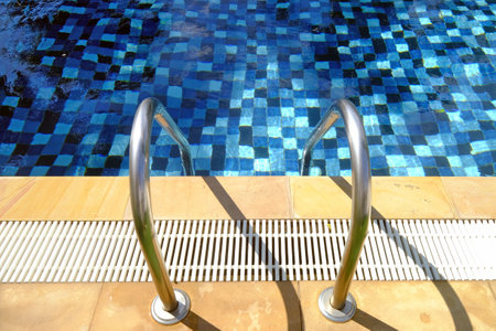 Stainless steel ladder or stairs of a swimming poolの写真素材