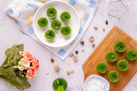 Kue Lumpang Pandan or Kue Ijo. 

"Kue Ijo" is a traditional green cake and is small in size, steamed and has a rubbery texture, served with grated coconut. It's Popular snack from indonesiaの写真素材