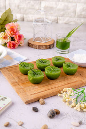 Kue Lumpang Pandan or Kue Ijo. 

"Kue Ijo" is a traditional green cake and is small in size, steamed and has a rubbery texture, served with grated coconut. It's Popular snack from indonesiaの写真素材