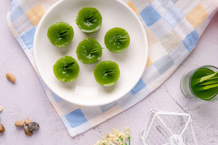 Kue Lumpang Pandan or Kue Ijo. 

"Kue Ijo" is a traditional green cake and is small in size, steamed and has a rubbery texture, served with grated coconut. It's Popular snack from indonesiaの写真素材