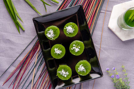 Kue Lumpang Pandan or Kue Ijo. 

"Kue Ijo" is a traditional green cake and is small in size, steamed and has a rubbery texture, served with grated coconut. It's Popular snack from indonesiaの写真素材