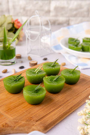 Kue Lumpang Pandan or Kue Ijo. 

"Kue Ijo" is a traditional green cake and is small in size, steamed and has a rubbery texture, served with grated coconut. It's Popular snack from indonesiaの写真素材