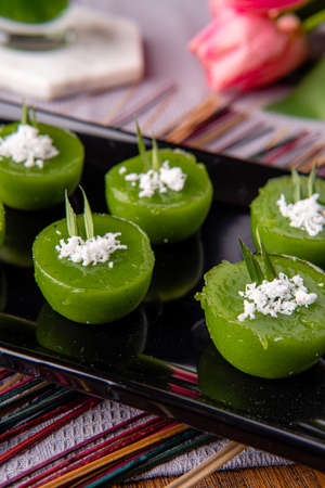 Kue Lumpang Pandan or Kue Ijo. 

"Kue Ijo" is a traditional green cake and is small in size, steamed and has a rubbery texture, served with grated coconut. It's Popular snack from indonesiaの写真素材