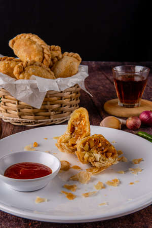 Curry puff or Pastel goreng. it is a small pie consisting of curry with chicken and potatoes in a...