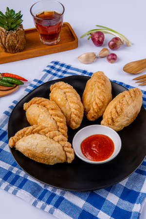 Curry puff or Pastel goreng. it is a small pie consisting of curry with chicken and potatoes in a...