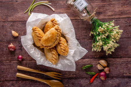 Curry puff or Pastel goreng. it is a small pie consisting of curry with chicken and potatoes in a deep-fried or baked pastry shell. The curry is quite thick to prevent it from oozing out of the snackの写真素材