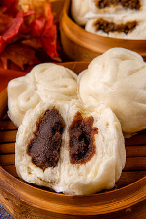 Baozi or Bakpao is a type of yeast-leavened filled bun in various Chinese cuisines. There are many variations in fillings (meat or vegetarian) and preparations, though the buns are most often steamed.の写真素材