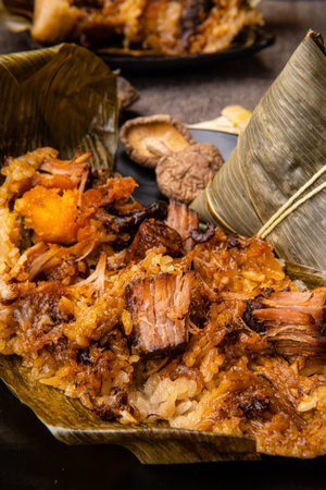 Zongzi or Bakcang is a traditional Chinese rice dish made of glutinous rice stuffed with different fillings and wrapped in bamboo leaves. They are cooked by steaming or boilingの写真素材