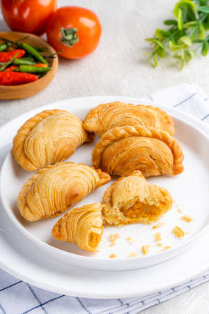 curry puff or kari pap is a snack of Maritime Southeast Asian origin.  It is a small pie consisting...