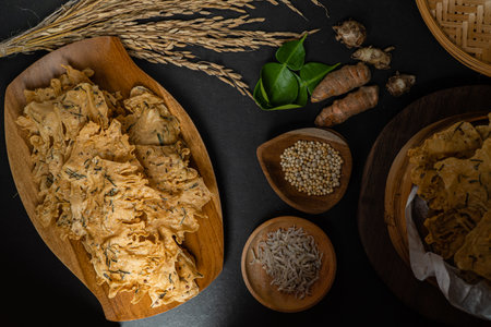 Rempeyek or peyek ikan teri, a deep-fried savoury Indonesian-Javanese cracker made from flour (usually rice flour), lime leaves and other ingredients, bound or coated by crispy flour batterの写真素材