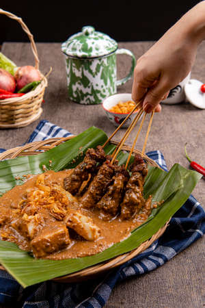 Pork Satay or Sate Babi. Pork Satay served with a Peanut sauce and slices of lontong or ketupat...