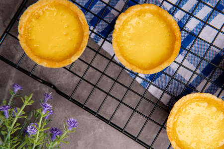 The egg tart  is a kind of custard tart found in Cantonese cuisine derived from the English custard tart and Portuguese pastel de nata. Egg tarts are often served at dim sum restaurants and cha chaanの写真素材