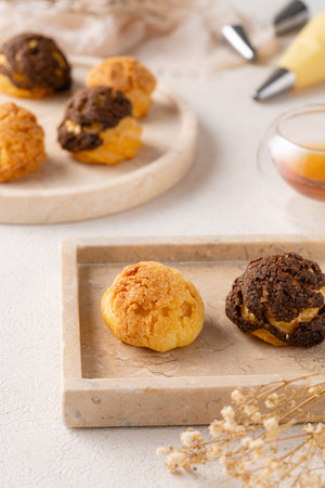 Choux pastry  is a delicate pastry dough used in many pastries. It contains only butter, water, flour, and eggs. Choux pastries are sometimes filled with cream after baking to make cream puffsの写真素材