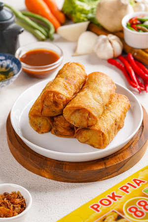 Lumpia or popiah are made of thin paper-like or crepe-like pastry skin called "lumpia wrapper" enveloping savory or sweet fillings. It is often served as an appetizer or snack.の写真素材