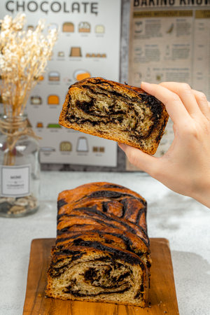 Chocolate Babka or Brioche Bread is prepared with a yeast-leavened dough that is rolled out and spread with a filling such as chocolate, fruit, or cheese, then rolled up and braided before baking.の写真素材