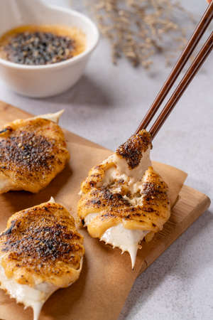 Grilled Crab with mentaiyaki sauce. Mentaiyaki is a typical Japanese sauce made from cod or pullock fish eggs mixed with mayonnaise and is usually processed or mixed in Japanese food.の写真素材