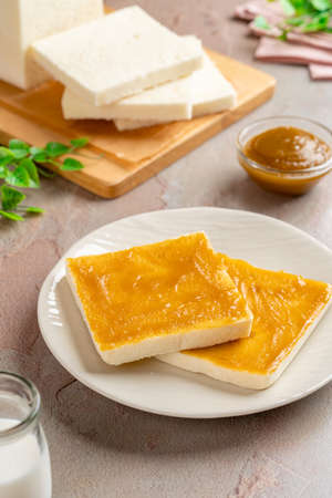 Sliced White Bread with kaya Jam. Coconut jam, also known as kaya jam, is a sweet spread made from a base of coconut milk, eggs and sugar.の写真素材