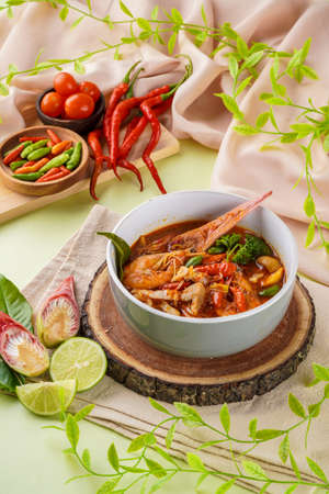 Tom yum or tom yam is a type of hot and sour Thai soup, usually cooked with shrimp (prawn). Tom yum has its origin in Thailand.の写真素材