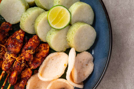 Sate Kacang or Chicken satay is Indonesian traditional Food skewered with grilled meat and rice cake , served with peanut sauceの写真素材