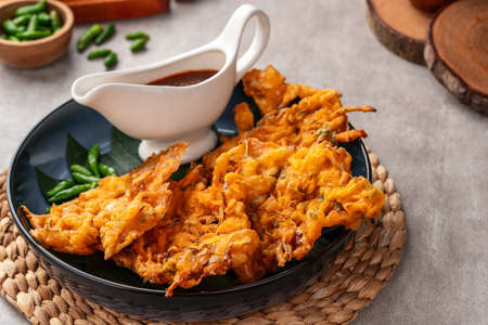 Bakwan is a vegetable fritter or gorengan from Indonesian cuisine.The ingredients are vegetables, usually beansprouts, shredded cabbages and carrots, battered and deep fried in cooの写真素材