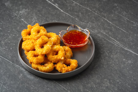 Deep fried squid rings breaded with thai sauce.の写真素材