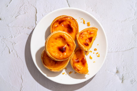 Egg tart, traditional Portuguese dessert, pastel de nata. Pasteis de Belem is a Portuguese egg...