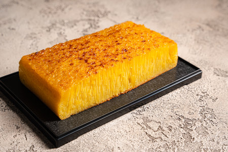 Bika ambon or golden cake or golden kuih bingka in Singapore, is an Indonesian dessert, made from ingredients such as tapioca flour, eggs, sugar, yeast and coconut milk.の写真素材