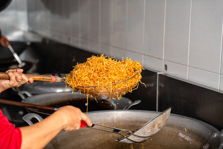 Dried potato or potato mustofa (indonesian : Kering Kentang Potato Balado) is the term for dry match-shaped potatoes stir-fried with Indonesian spices.の写真素材