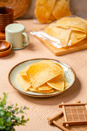 Breadfruit chips (Indonesia : Keripik sukun) are food made from breadfruit which is thinly sliced and then fried until dry and crispy. It tastes salty and is usually given a savory onion aroma.の写真素材