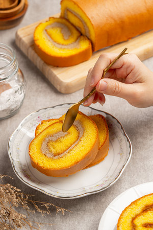 mocha roll cake (Indonesia bolu gulung moka) Bolu Gulung is a sponge cake that is baked using a shallow pan, filled with jam or butter cream and then rolled.の写真素材