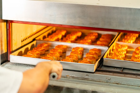 Mooncake making process. A mooncake  is a Chinese bakery product traditionally eaten during the...