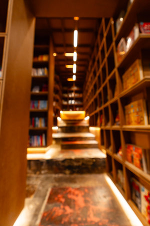 Abstract blurred public library interior space. blurry room with bookshelves by defocused effect....