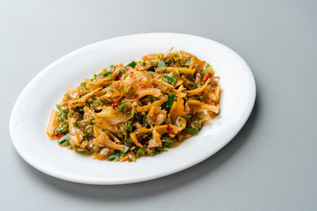 Fried anchovy cooked with green chili or ikan teri cabe ijo is a traditional food from west sumatra, Indonesia.の写真素材