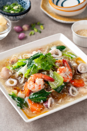 kwetiau siram is Chinese cuisine which is popular in Indonesia, cooked by frying added with complementary vegetables and chicken, seafood or beef meat and thick soup.の写真素材