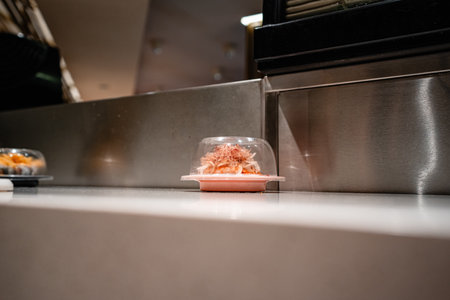 various types of sushi on conveyor belt in a Japanese restaurant. Shushi Go Round is a famous form of fast food in Asia, also known as sushi train.の写真素材
