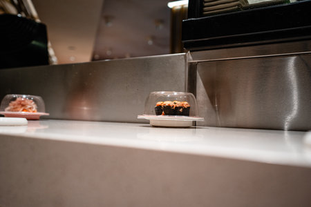 various types of sushi on conveyor belt in a Japanese restaurant. Shushi Go Round is a famous form of fast food in Asia, also known as sushi train.の写真素材