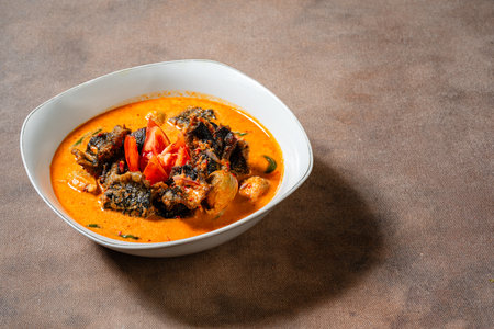 Fried eel or belut asam cikala cooked in spicy sour curry is a popular dish made from freshwater eel from sumatraの写真素材