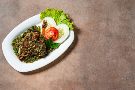 Bebek goreng cabe ijo or fried duck with green chili sauce. Traditional cuisine from West Sumatra, Indonesia.の写真素材